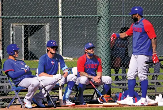  ?? JAE C. HONG/AP ?? Anthony Rizzo (from left), Kris Bryant, coach Mike Napoli and Jason Heyward chat during a spring-training workout in late February.