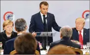  ?? JACQUES DEMARTHON / AP ?? German Chancellor Angela Merkel and President Donald Trump listen to French President Emmanuel Macron deliver a speech Saturday.