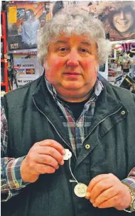  ?? ?? Aidan Mannion, an avid history lover, with a medal which celebrates the ‘Heroes of Collooney’ who fought in the 1798 ‘Battle of Carricknag­at’.