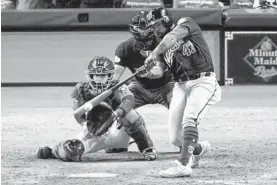  ?? ERIC GAY/AP ?? Howie Kendrick hits a two-run home run against the Astros in Game 7 of the World Series.