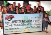  ?? SUBMITTED PHOTO ?? The A-Team nonprofit group presented 11-year-old Maverik Laxton of Amity Township with a check for $20,000 at a fundraiser for another of the group’s causes held at Maenner-Chor Club on Sept. 18.