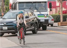  ?? Salgu Wissmath/The Chronicle ?? Sabrina Glazebrook of Berkeley, who supports adding bike lanes, rides along Hopkins Street. Some merchants in the city would rather see more car parking.