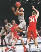  ?? ASSOCIATED PRESS FILE PHOTO ?? The Lobos’ JJ Caldwell, center, is shown during a Nov. 26 game in the Legends Classic at Barclays Center in New York. The junior guard has been charged with misdemeano­r battery against a household member.