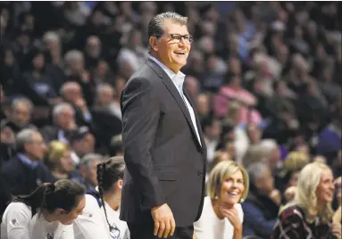  ?? Jessica Hill / Associated Press ?? UConn head coach Geno Auriemma won his 1,000th career game after the Huskies’ 88-64 victory over Oklahoma on Tuesday. At right is Chris Dailey, who has been an assistant under Auriemma for every one of those victories.