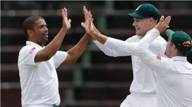  ??  ?? HE’S GOT THE MOVES LIKE JAGGER: Vernon Philander celebrates with his teammates after dismissing Murali Vijay at the Wanderers yesterday.