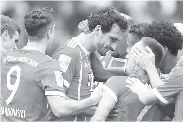  ??  ?? Bayern Munich’s German defender Mats Hummels (C) celebrates scoring the opening goal with his teammates during the German first division Bundesliga football match between Hertha Berlin and FC Bayern Munich in Berlin. - AFP photo