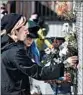  ?? JOSH EDELSON/AP ?? Mourners place flowers near the site Saturday. Arson is not suspected.