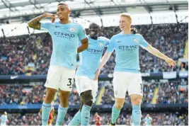  ??  ?? Gabriel Jesus of Manchester City celebrates scoring his side’s second goal with team mates; Kevin De Bruyne and Benjamin Mendy during the Premier League match between Manchester City and Liverpool yesterday