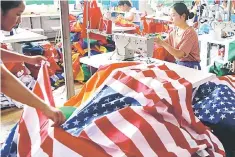  ?? — Reuters photo ?? A worker makes US national flags at Jiahao flag factory in Fuyang, Anhui province, China July 24, 2018. Picture taken July 24, 2018.