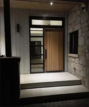  ??  ?? Contempora­ry door - This stunning front door revels the clean, contempora­ry design of the home’s architectu­re