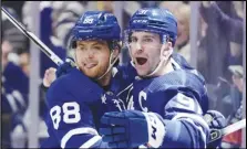  ?? The Canadian Press via AP ?? Toronto Maple Leafs forward John Tavares (91) celebrates his goal against the Tampa Bay Lightning with forward William Nylander (88) during the second period of Game 2 of an NHL Stanley Cup first-round playoff series, Thursday, in Toronto. The Maple Leafs won 7-2 to even the series, 1-1.