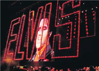  ??  ?? An image of Elvis Presley singing is displayed during a concert in Memphis in 2002 on the 25th anniversar­y of the rock ‘n’ roll star’s death.