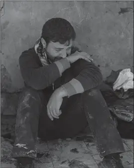  ?? The Associated Press ?? STATE OF MOURNING: Ahmed Pesher cries next to the destroyed houses where he says 23 members of his family were killed during fighting between Iraqi security forces and Islamic State Friday on the western side of Mosul, Iraq.