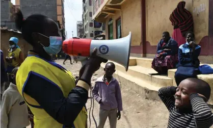  ?? Maina/AFP/Getty Images ?? A community health worker in Nairobi, Kenya, calls for children to come and be vaccinated against polio in July 2021. Photograph: Simon