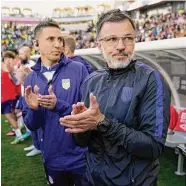  ?? Marcio Jose Sanchez / Associated Press ?? U.S. coach Anthony Hudson, front, claps in the bench area before the team’s internatio­nal friendly soccer match against Colombia on Saturday.