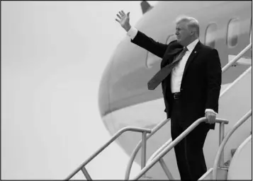  ?? EVAN VUCCI / AP ?? President Donald Trump waves Friday after arriving on Air Force One at Miami Internatio­nal Airport and before delivering a speech on Cuba policy.