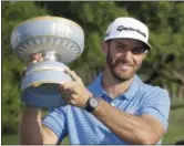  ?? ERIC GAY — THE ASSOCIATED PRESS ?? Dustin Johnson holds his trophy after defeating Jon Rahm at the Match Play tournament at Austin County Club March 26 in Austin, Texas.