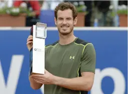  ?? — AFP ?? Andy Murray poses with the trophy after beating Philipp Kohlschrei­ber in the final of the BMW Open in Munich on Sunday. Murray won 7- 6 ( 7/ 4), 5- 7, 7- 6 ( 7/ 4).