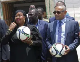  ?? FARAH ABDI WARSAMEH — THE ASSOCIATED PRESS ?? In this Monday, April 17, 2017 photo, Confederat­ion of African Football President Ahmad Ahmad, right, and Somali Sports Minister Khadija Mohamed Dirie, left, poses for a photo during a tour to a soccer stadium in Mogadishu, Somalia. Ahmad arrived in...