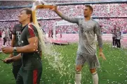  ?? Picture: REUTERS ?? SHOWERS OF BLESSING: Bayern Munich’s Manuel Neuer, right, celebrates winning the Bundesliga