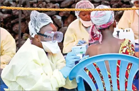 ?? AUGUSTIN WAMENYA/AFP ?? A girl receives a vaccine against Ebola from a nurse in Goma on August 7.
