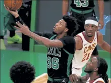  ?? NANCY LANE / BOSTON HERALD FILE ?? Boston Celtics guard Marcus Smart drives past Cleveland Cavaliers guard Damyean Dotson during the first quarter at TD Garden on Sunday.