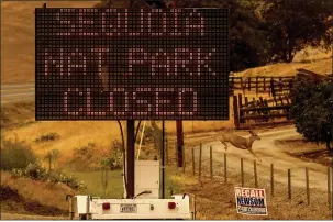  ??  ?? A sign announces the closure of Sequoia National Park, where the KNP Complex Fires are burning, Tuesday in Tulare County.