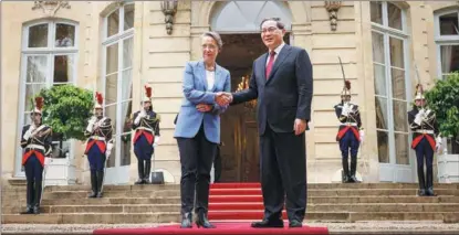  ?? THOMAS PADILLA / AP ?? French Prime Minister Elisabeth Borne and Chinese Premier Li Qiang shake hands before their talks, in Paris, on June 22.