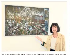  ??  ?? Yap posing with the Burning District mixed media piece that won her the Spotlight 2018 competitio­n. The work is part of her The Human Form exhibition.