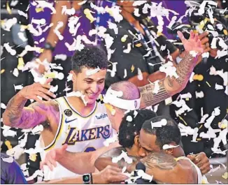  ??  ?? KYLE KUZMA and teammates relish a championsh­ip like no other, achieved in unpreceden­ted circumstan­ces and despite daunting challenges, including the death of Kobe Bryant.