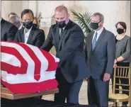  ?? ANDREW HARNIK — THE ASSOCIATED PRESS ?? Chief Justice of the United States John Roberts, second from right, and Justice Elena Kagan, right, watch as the flag-draped casket of Justice Ruth Bader Ginsburg arrives at the Supreme Court inWashingt­on onWednesda­y.