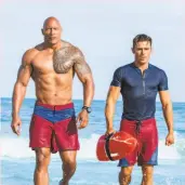  ?? Frank Masi / Paramount Pictures ?? Dwayne Johnson (left) and Zac Efron in the big-screen “Baywatch.”