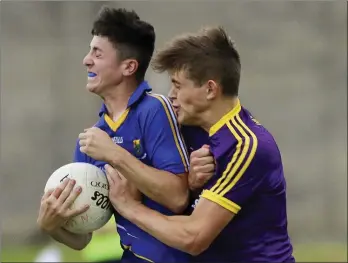  ??  ?? Wicklow’s Jack Manley feels the force of this challenge from Wexford full-back Tommy Ryan.