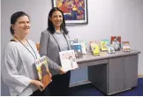  ?? ADOLPHE PIERRE-LOUIS/JOURNAL ?? Rachel Altobelli, director of library services and instructio­nal materials, left, and Jessica Villalobos, senior director of language and cultural equity, show some of the new books at APS.