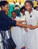  ??  ?? Parents and their children buy school uniforms in Bulawayo yesterday