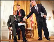  ?? DOUG MILLS / AP, FILE ?? President Clinton and Vice President Al Gore, back, help Herman Shaw, 94, a Tuskegee Syphilis Study victim, during a news conference on May 16, 1997.