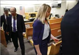  ?? TOM FOX — THE DALLAS MORNING NEWS VIA AP, POOL ?? Fired Dallas police officer Amber Guyger leaves the Dallas courtroom after a jury found her guilty Tuesday of murdering Botham Jean, an unarmed 26-year-old neighbor.
