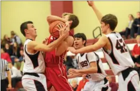  ?? SAM STEWART - DIGITAL FIRST MEDIA ?? Boyertown’s Ryan Meier, left, and Keegan Schealer, right, try to pry the ball away from a CB East player during the first half.