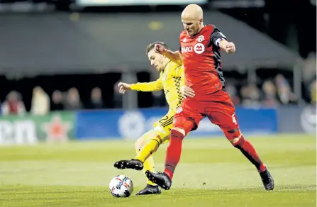  ?? KIRK IRWIN/GETTY IMAGES ?? Columbus Crew SC’s Pedro Santos and Toronto FC’s Michael Bradley battle for control of the ball during the first half at MAPFRE Stadium, on Tuesday, in Columbus.