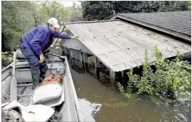  ?? GERRY BROOME / ASSOCIATED PRESS ?? Florence, South Carolina, resident Jackie Lee surveys the flooding on his property Tuesday, where houses and cars were swamped following record rainfall in the state. In Columbia, the state capital, Tuesday was the first dry day since Sept. 24.“We...