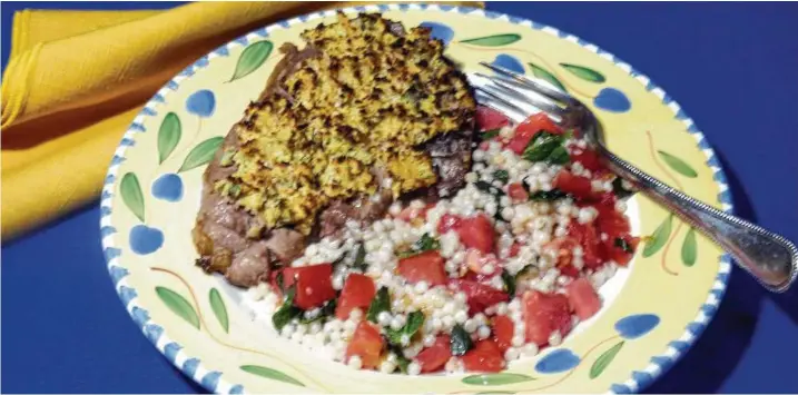  ?? Linda Gassenheim­er / Tribune News Service ?? Herb-Crusted Lamb Chops with Tomato Mint Couscous.