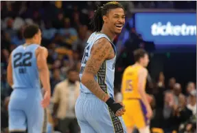  ?? The Associated Press ?? Memphis Grizzlies guard Ja Morant (12) is facing renewed scrutiny for a social media post that again showed him brandishin­g a weapon.