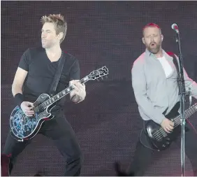  ?? RICHARD MARJAN/The StarPhoeni­x ?? Not as bad as you’d think: Chad Kroeger, left, and Mike Kroeger of Nickelback jam
on their guitars Tuesday at SaskTel Centre in Saskatoon.