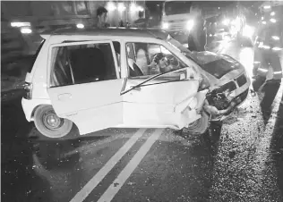  ??  ?? One of the compact cars involved in the two-vehicle collision at Jalan Batu Kitang.