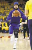  ?? Scott Strazzante / The Chronicle ?? Stephen Curry is shown wearing a large knee brace before Saturday’s game.