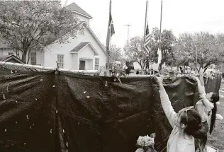  ?? Express-news file photo ?? Visitors place flowers on the fence outside the First Baptist Church of Sutherland Springs in 2017. Twenty-six people were killed by a gunman at the church; the mass shooting is the subject of a new documentar­y.