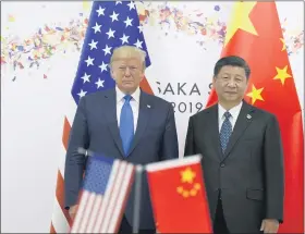  ?? SUSAN WALSH — THE ASSOCIATED PRESS FILE ?? In this June 29, 2019, file photo President Donald Trump, left, poses for a photo with Chinese President Xi Jinping during a meeting on the sidelines of the G-20 summit in Osaka, Japan.