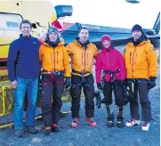  ?? ICEFIELD DISCOVERY TOURS / LANCE GOODWIN / THE CANADIAN PRESS ?? Climber Natalia Martinez, second from right, is seen Thursday after her rescue. With her are, from left, pilot Ian Pitchforth, and members of the Kluane National Parks rescue crew Sarah Chisholm, Scott Stewart and David Blakeburn.