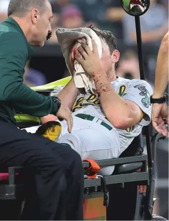  ?? GETTY IMAGES ?? Athletics starter Chris Bassitt is carted off the field after being hit in the face by a line drive from Brian Goodwin in the second inning. He was taken to a hospital and was “conscious and aware.”