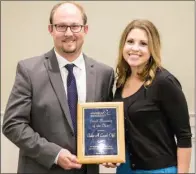  ??  ?? Brady and Kristen Brandon, owners of Take A Load Off, accept the award for Small Business of the Year.